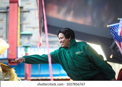 Washington, DC - February 18, 2018: The Chinese New Year Parade Takes Place In Chinatown. Mayor Muriel Bowser Feeds A Dancing Dragon A Note. 