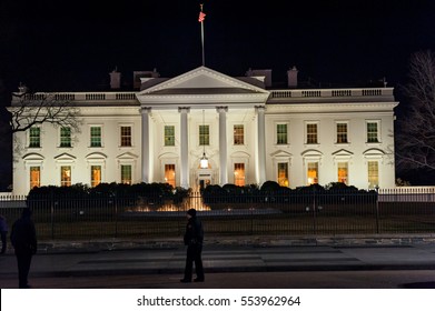 WASHINGTON, D.C. - JANUARY 09, 2014: White House At Night. With Police Officer In Foreground.