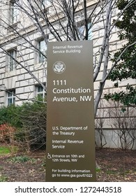 WASHINGTON, DC - JANUARY 1, 2019: IRS - Internal Revenue Service Headquarters Building, Sign With Headquarters Office In Background.