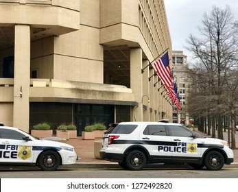 WASHINGTON, DC - JANUARY 1, 2019: FBI - FEDERAL BUREAU OF INVESTIGATION - FBI headquarters building with FBI Police car vehicles and flags.