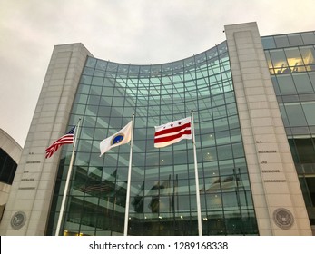 WASHINGTON, DC - JANUARY 19, 2019: SEC - SECURITIES AND EXCHANGE COMMISSION- sign at entrance to DC headquarters building with flags.