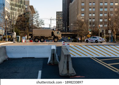 Washington, DC – January 19, 2021: National Guard Troops And Police Guarding The Perimeter Security Fence At The U.S. Capitol And National Mall Day Before Inauguration. Military Truck Street Blockage.