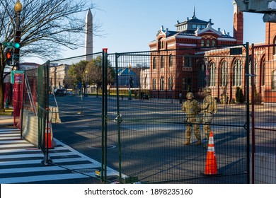 Washington, DC – January 19, 2021: National Guard Troops And Police Guarding The Security Fence At The U.S. Capitol And National Mall Before The Inauguration. Smithsonian And Washington Monument.