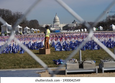 Washington, DC – January 21, 2021: Workers Busily Removing Flags From The National Mall The Day After The Biden Inauguration.