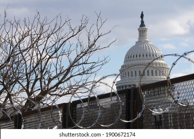 Washington, DC – January 22, 2021: A view of the U.S. Capitol Building as seen from outside the razor wire topped security fence installed after the unsuccessful insurrection on January 6th.