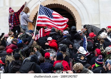 Washington, DC - January 6, 2021: Rioters clash with police trying to enter Capitol building through the front doors