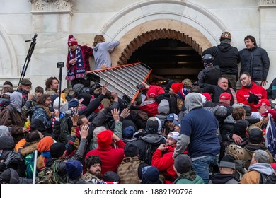 Washington, DC - January 6, 2021: Rioters clash with police trying to enter Capitol building through the front doors