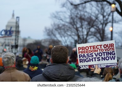 Washington, DC – January 6, 2022: Demonstrators at the Save Our Democracy candlelight vigil rally on the National Mall holding signs demanding the Senate pass the John Lewis Voting Rights Act.