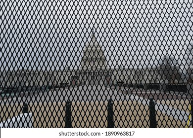 Washington, DC – January 8, 2021: A view of the U.S. Capitol through the recently installed security barrier in the aftermath of the storming if the building by Trump supporters.