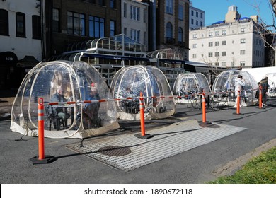 Washington, DC – January 9, 2021: Diners At A Restaurant Eating In Separate Enclosed Igloo Tents During The Covid Pandemic.