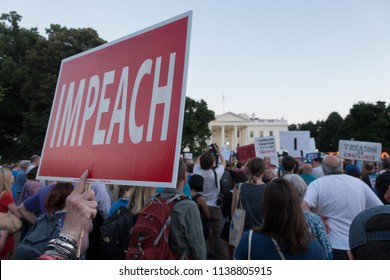 WASHINGTON, DC - JULY 18, 2018: Demonstrators outside White House protesting President Donald Trumps "treasonous" relationship with Russian President Vladimir Putin at early evening protest. 