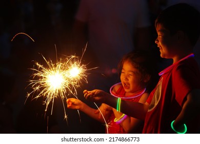 WASHINGTON, DC - July 4, 2022: Kids Play With Sparklers At The Fourth Of July Celebration On The National Mall.