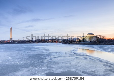 Washington DC landmarks along the frozen Potomac River at the Tidal Basin in Washington, DC at daybreak.