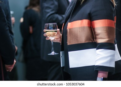 Washington, DC - March 15, 2018: An Influential Woman Holds A Glass Of Wine During A Corporate Networking Event And Panel Discussion.