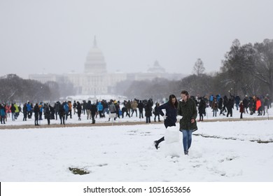 Washington, DC - March 21, 2018: A NorEaster snow storm slams the East Coast. People gather for a snowball fight on the National Mall.