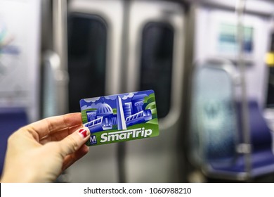 Washington, DC - March 31, 2018: A Woman Holds A SmarTrip Metro Card While Underground In The Metrorail System.