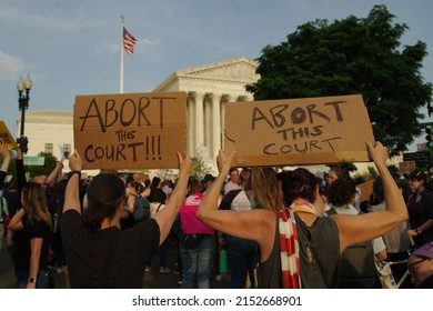 WASHINGTON, DC - May 3, 2022: Pro-choice demonstrators hold up signs at a protest at the U.S. Supreme Court. 