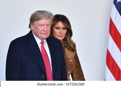 WASHINGTON, DC - NOVEMBER 26, 2019: President Donald Trump And First Lady Melania Trump Walk Into The White House Rose Garden From The Oval Office During The Annual Thanksgiving Turkey Pardon.