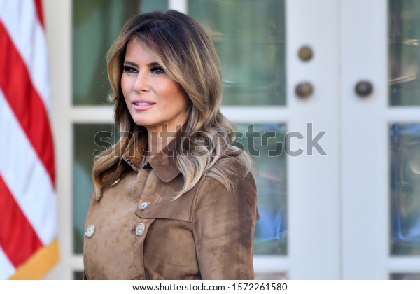 WASHINGTON, DC - NOVEMBER 26, 2019: First\
Lady Melania Trump stands in the Rose Garden of the White House\
with a jovial disposition as the President pardons the Thanksgiving\
Turkey named\
\