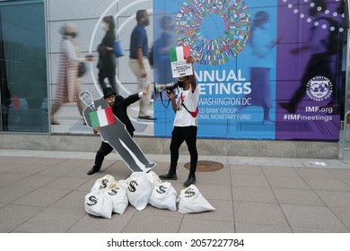 Washington, DC – October 13, 2021: A Protester Dressed As Rich Uncle Pennybags Holds Italian Prime Minister Mario Draghi While An Activist Demands To Know Where Italy's Promised Climate Monies Are.