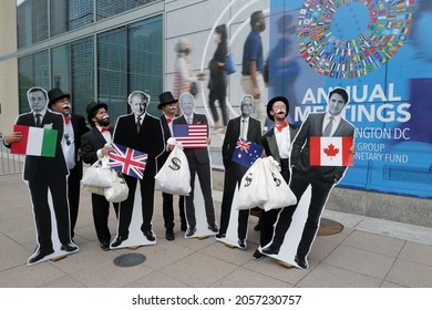 Washington, DC – October 13, 2021: Protesters Dressed As Rich Uncle Pennybags Hold Cutouts Of Five World Leaders Asking For Accountability Of Climate Financing That Has Not Been Paid By Them.