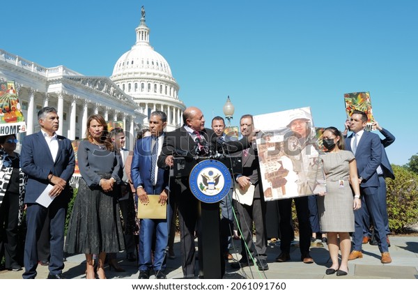 Washington, DC – October 20, 2021: California\
Congressman Luis Correa holds an enlarged photograph of Marine Jose\
Angel Garibay, a Dreamer killed in action in Iraq at Capitol Hill\
news conference.