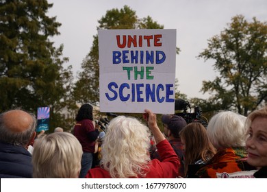 Washington, DC – October 25, 2019: A Fire Drill Friday, Climate Change Protester At The U.S. Capitol With A Sign Urging Trump To Believe In Science. Words That Are Now More Prophetic Than Ever.