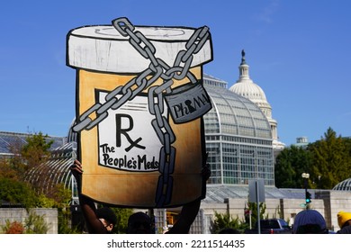 Washington, DC – October 6, 2022: An Activist Holds A Large Chained Cardboard Prescription Bottle Aloft To Protest Against High Drug Prices.