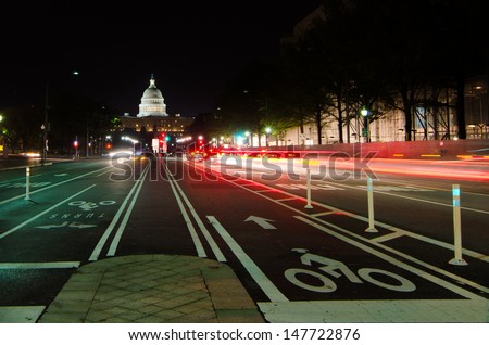 Washington DC, United States Capitol building night view from from Pennsylvania Avenue with car lights trails 