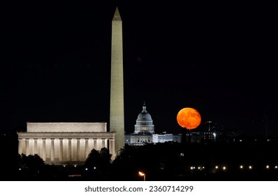 WASHINGTON DC, UNITED STATES - The moon rises behind the world-famous landmark of the US Capitol building in Washington D.C., United States. - Powered by Shutterstock