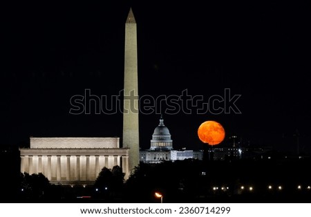 WASHINGTON DC, UNITED STATES - The moon rises behind the world-famous landmark of the US Capitol building in Washington D.C., United States.