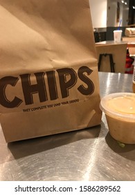 Washington DC / US - August 08, 2018: Carry Out Delivery From Chipotle Retail Location, Fried Corn Chips In A Bag Plus Queso Cheese Side Dish Order