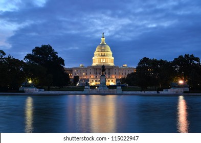 Washington DC, US Capitol Building In A Cloudy Sunrise With Mirror Reflection