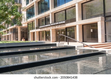 Washington, D.C., US - June 23, 2021: Ground Street Level Glass Door Closed Entrance To The Consumer Financial Protection Bureau Headquarters Office Building In A Plaza With A Water Fountain Feature