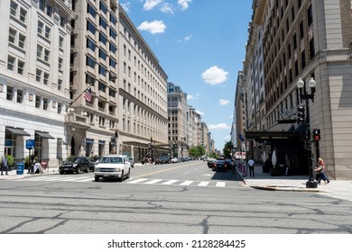 Washington, DC, US - June 23, 2021: White American Made SUV Makes Left Turn At Downtown DC Urban Street Intersection With The Hotel Washington On The Corner