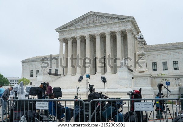 Washington, DC US - May 3, 2022: The Supreme\
Court with metal barricades and a media area nest to where\
protestors are gathering one day after the leaked draft opinion Roe\
V Wade confirmed\
authentic