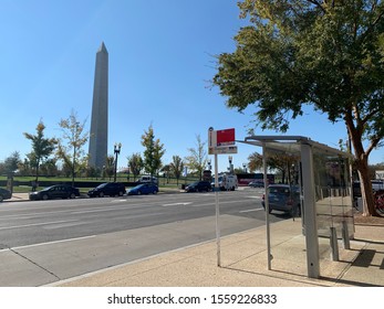 Washington, DC / US - November 06, 2019: DC Metro Bus Stop With Glass Covering And A View Of The Washington Monument