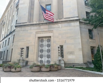 Washington, DC / US - September 27 2019: US Department Of Justice Department Building Emergency Exit/entrance With American Flag Above Door.