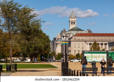 Washington DC, USA 11-02-2020: View Of National Mall Near Smithsonian Museum Complex. Tourists Are Looking At A Large Map Of The Location. In The Background There Is Smithsonian Castle And Art Gallery