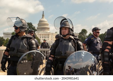 Washington, D.C., USA - 18 September 2021: United States Capitol Building , Blurred In Foreground: Officers Of The United States Capitol Police In Full Body Armor During A Protest