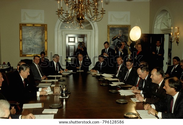 Washington DC., USA, 22nd, December,\
1988\
President Ronald Reagan and Vice President George H.W. Bush\
preside over a congressional budget committee meeting in the\
Cabinet Room of the White\
House.\

