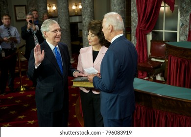 Washington DC., USA 6th January, 2015
Opening Day Of The 114th Congress. Senator Mitch McConnell With His Wife Elaine Chao Holding The Bible Is Sworn In By  Vice-President Joseph Biden 