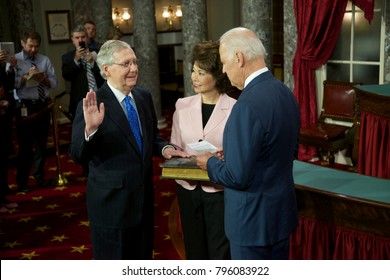 Washington DC., USA 6th January, 2015
Opening Day Of The 114th Congress. Senator Mitch McConnell With His Wife Elaine Chao Holding The Bible Is Sworn In By  Vice-President Joseph Biden 