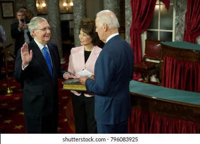 Washington DC., USA 6th January, 2015
Opening Day Of The 114th Congress. Senator Mitch McConnell With His Wife Elaine Chao Holding The Bible Is Sworn In By  Vice-President Joseph Biden 