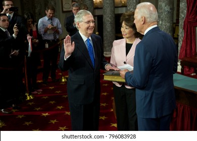 Washington DC., USA 6th January, 2015
Opening Day Of The 114th Congress. Senator Mitch McConnell With His Wife Elaine Chao Holding The Bible Is Sworn In By  Vice-President Joseph Biden 