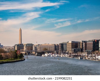 WASHINGTON, DC, USA - APRIL 2, 2022: Late Afternoon View Of Southwest Waterfront, With Marinas And Hotels In The Wharf Entertainment District, Along The Potomac River. (Washington Monument At Left.)