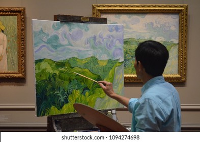 Washington, D.C. USA April 2017:
National Gallery Of Art. Unknown Asian Male Artist In Copyist Program Of The National Gallery Of Art. Oil Painting Of Vincent Van Gogh's 