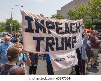WASHINGTON, DC, USA - APRIL 29, 2017: Climate March demonstrators protest, Impeach Trump sign.