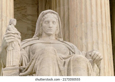 Washington, DC, USA - April 3, 2022: The Entrance To The Historic U.S. Supreme Court Building On Capitol Hill Is Flanked By Two Iconic Marble Figures Created By Renown Sculptor James Earl Fraser.