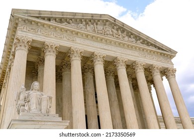 Washington, DC, USA - April 3, 2022: The Entrance To The Historic U.S. Supreme Court Building On Capitol Hill Is Flanked By Two Iconic Marble Figures Created By Renown Sculptor James Earl Fraser.